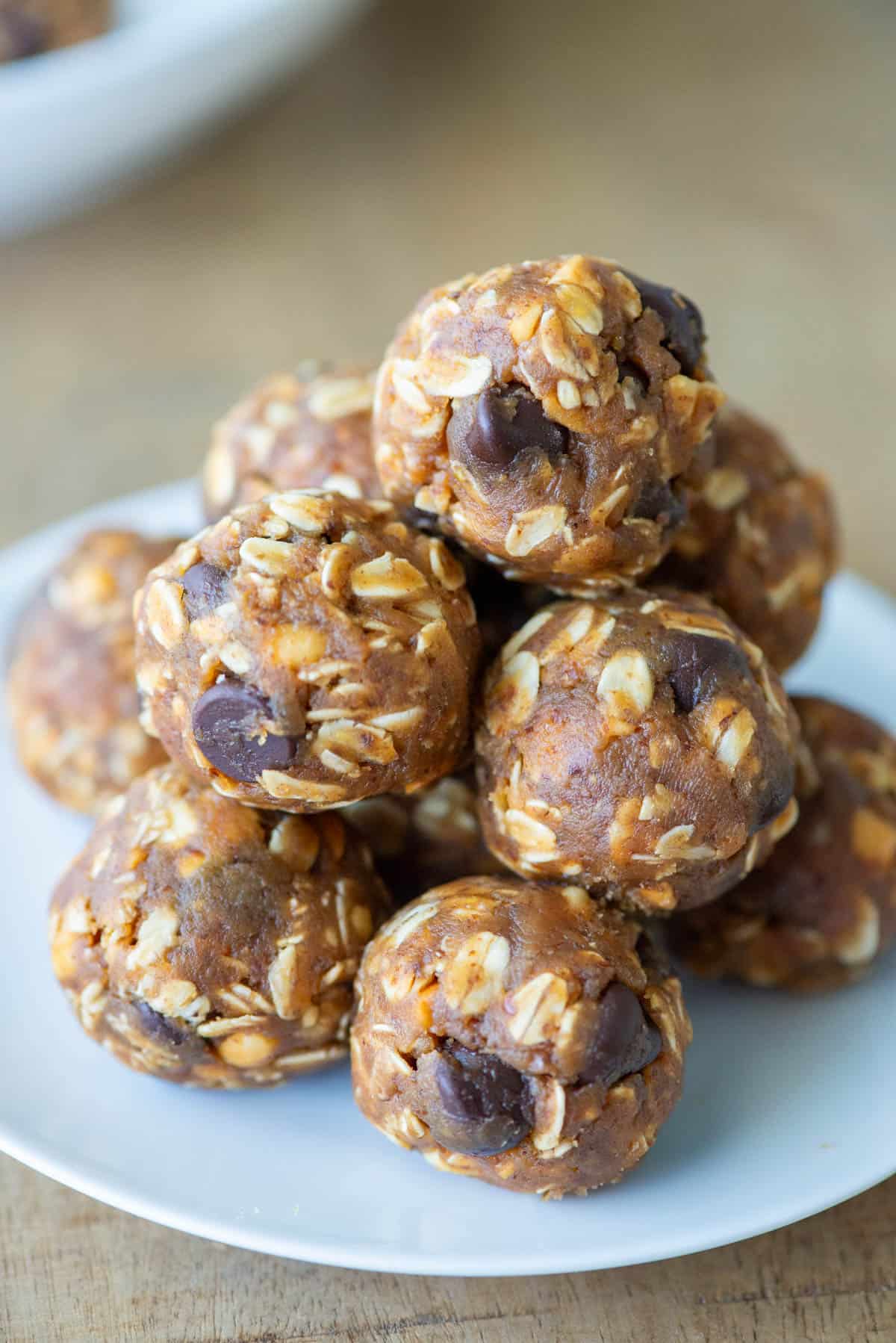 Side view of no bake oatmeal peanut butter balls stacked on a plate