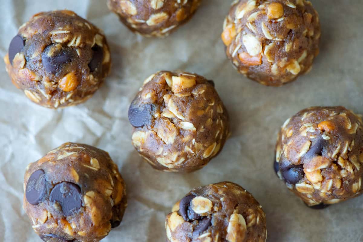 Overhead view of no bake peanut butter balls on crinkled parchment paper