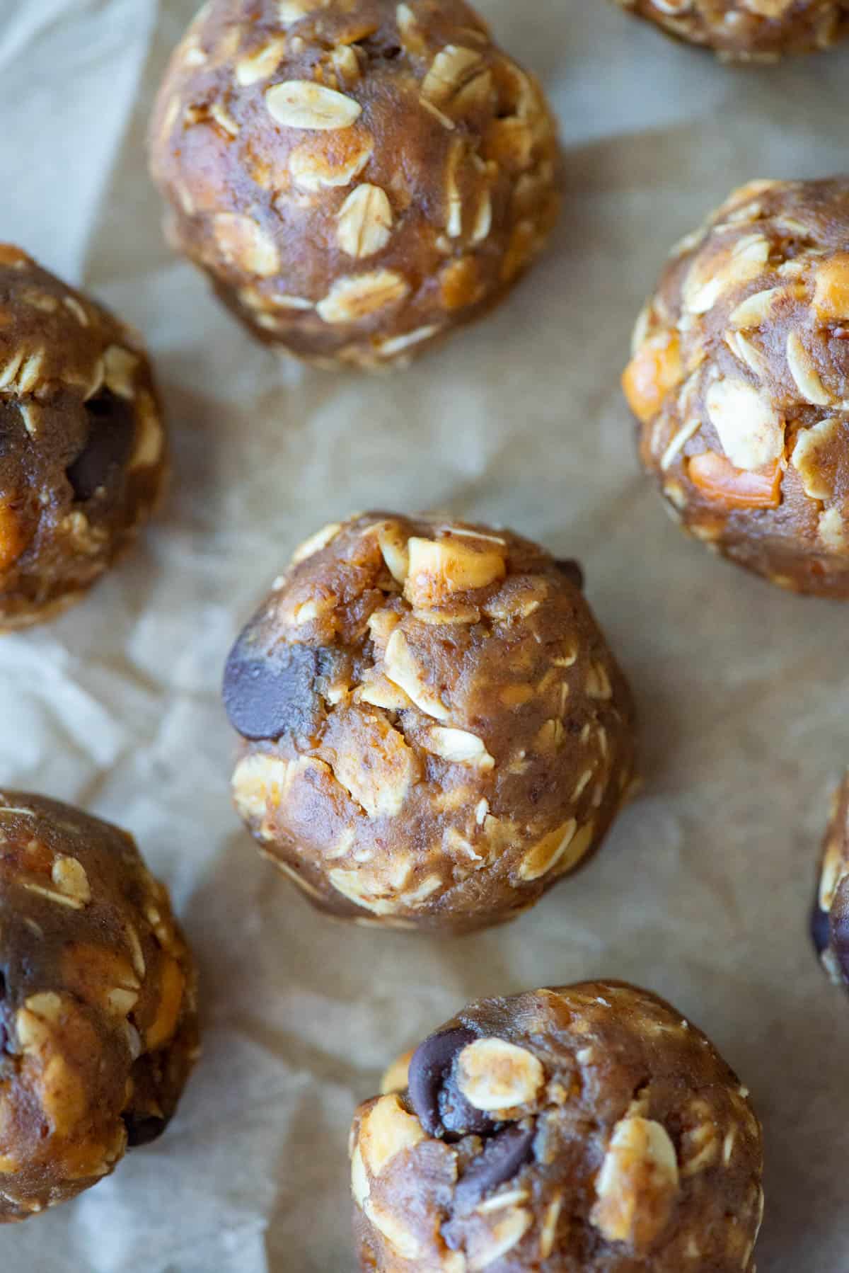 Overhead view of no bake peanut butter oatmeal balls on crinkled parchment paper