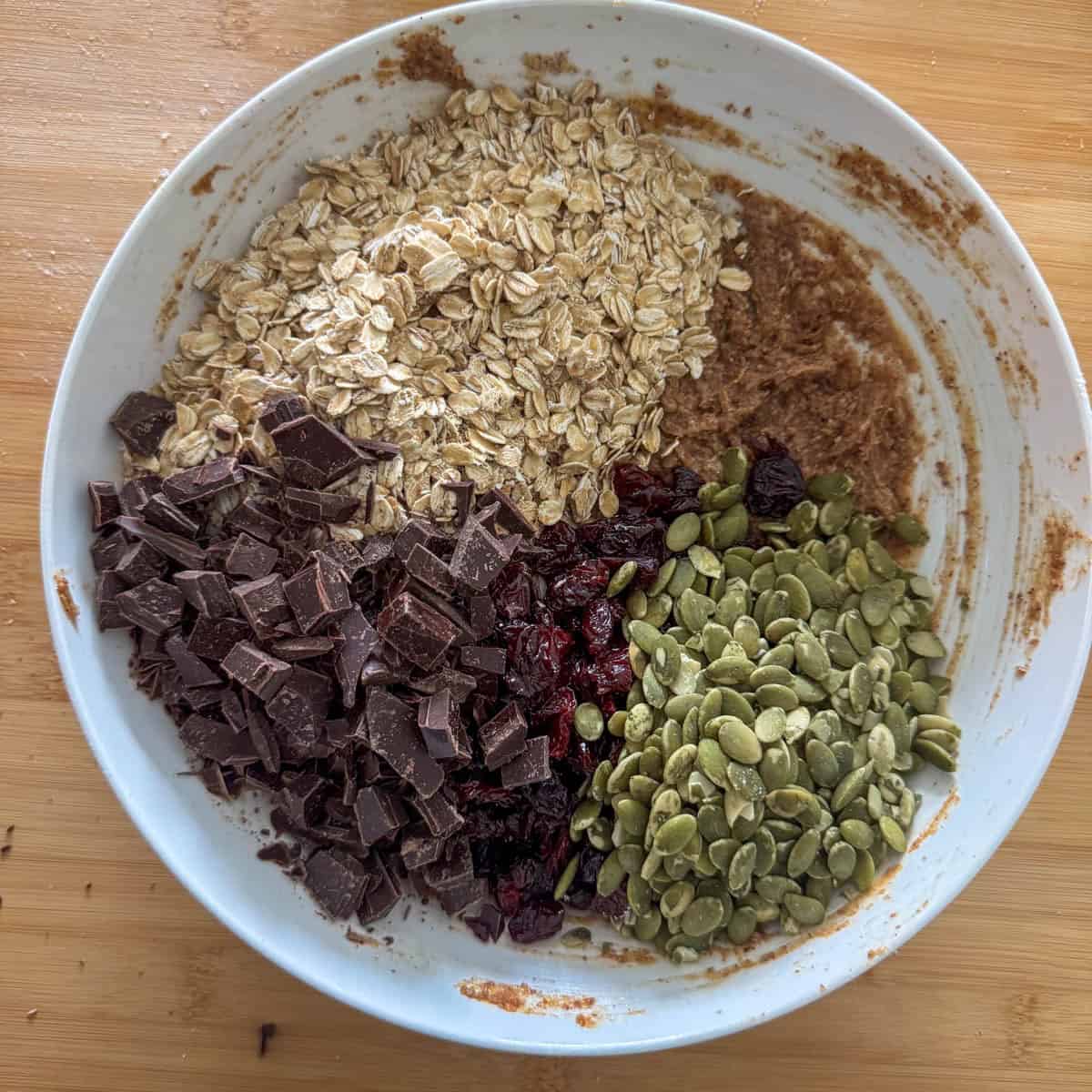 Green pumpkin seeds, oatmeal, dried cherries and dark chocolate chunks added to the mixing bowl