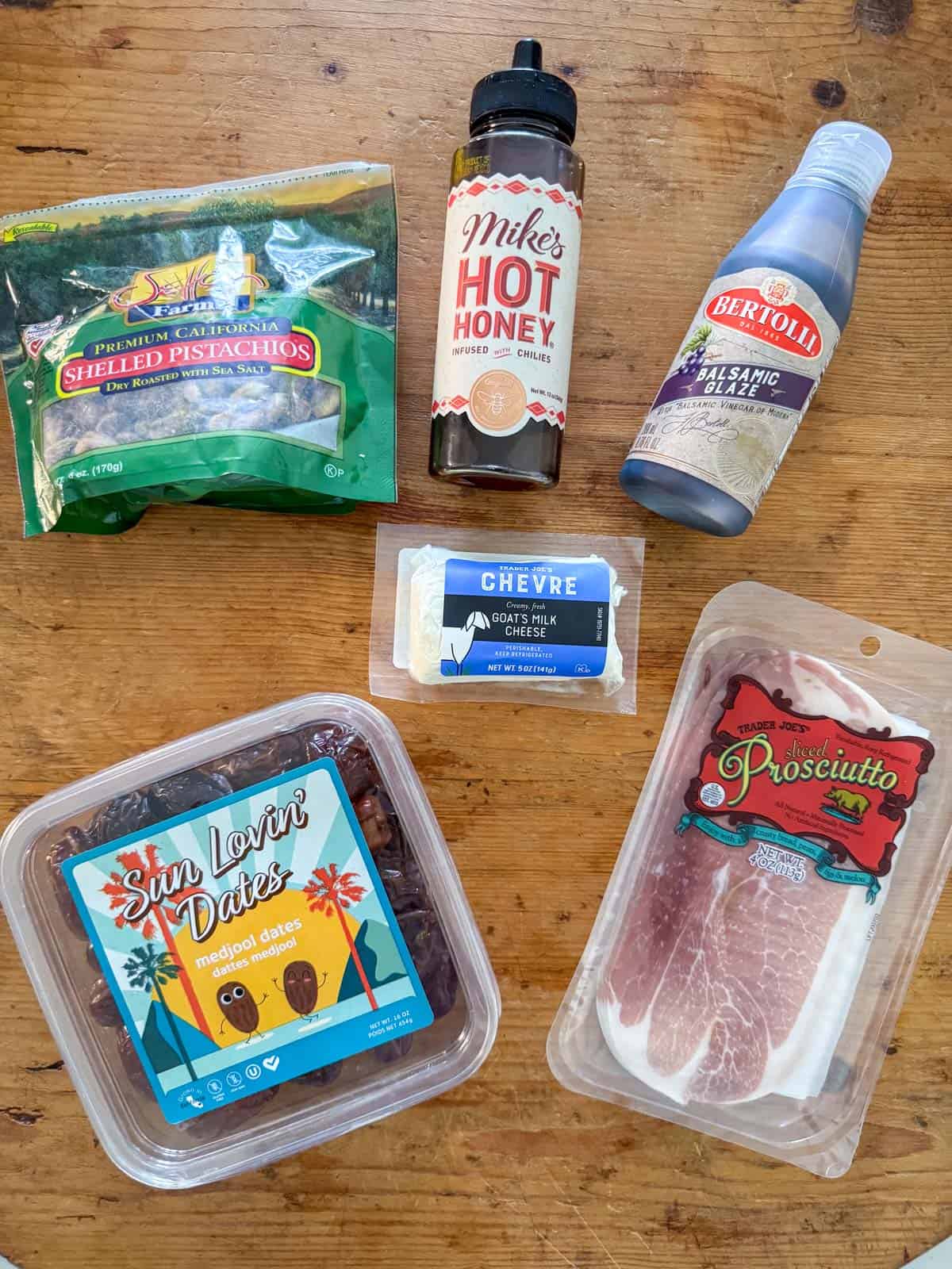 Overhead photos of ingredients needed to make prosciutto wrapped dates: dates, goat cheese, prosciutto, balsamic glaze (optional), hot honey (optional) and pistachios (optional)