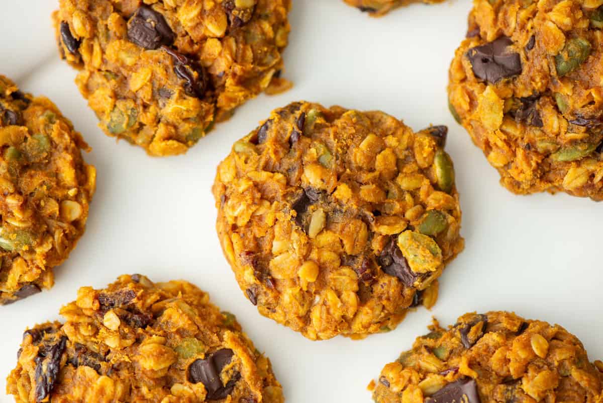 Overhead view of 5 pumpkin breakfast cookies on a white plate