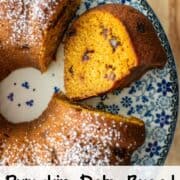 Overhead photo of a partial pumpkin date bread made in a bundt pan with one slice cut out and flipped on its side so that you can see the inside of the bread with a title overlay that says Pumpkin Date Bread