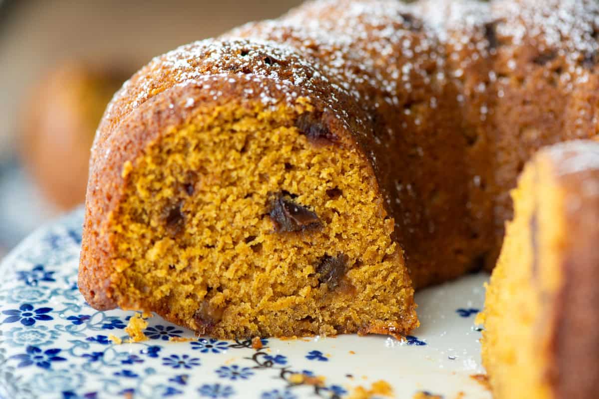 Side view of a loaf of pumpkin date bread made in a Bundt pan