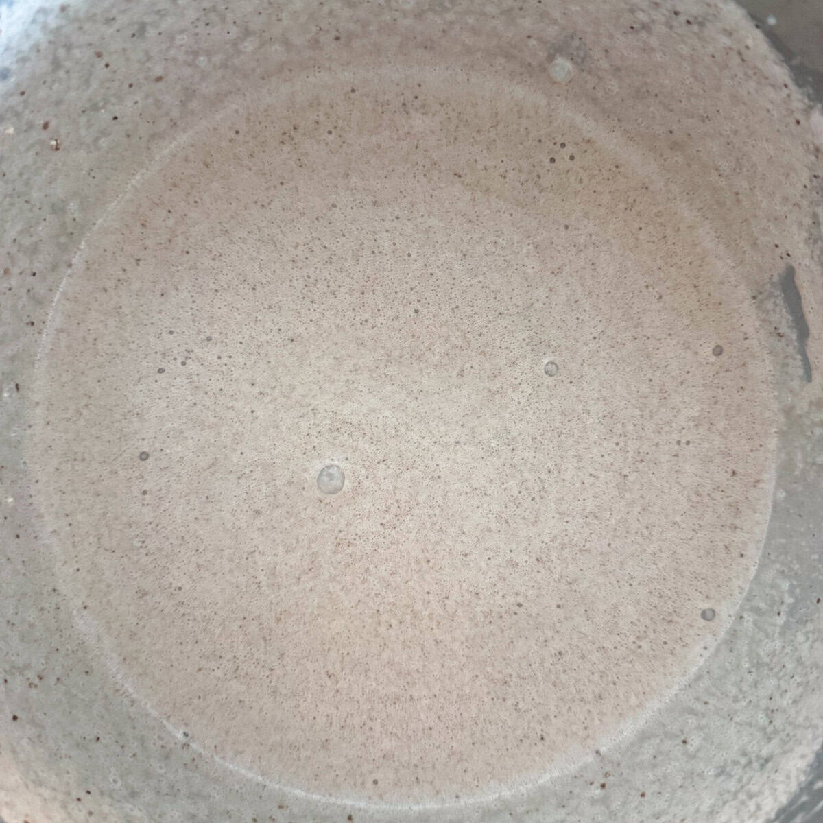All ingredients for chocolate malt ice cream in a mixing bowl after they have been mixed in the mixer.