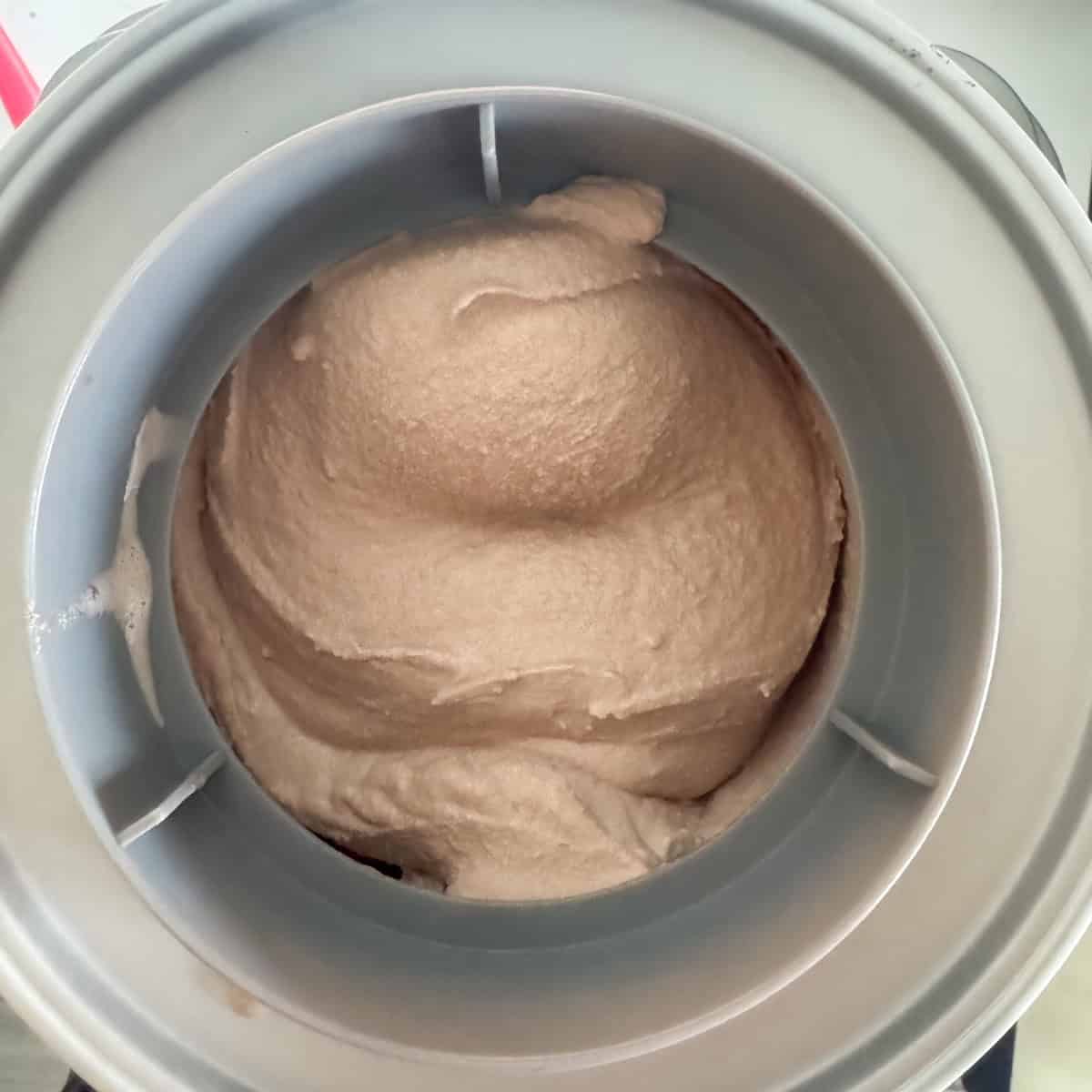 Overhead view of chocolate malt ice cream after it has churned in an electric ice cream maker for 25 minutes.