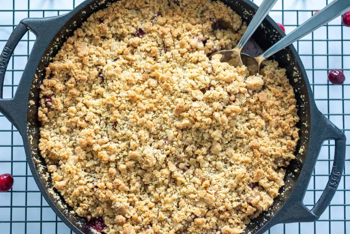 Over photo of a finished cranberry apple crumble on a cooling rack