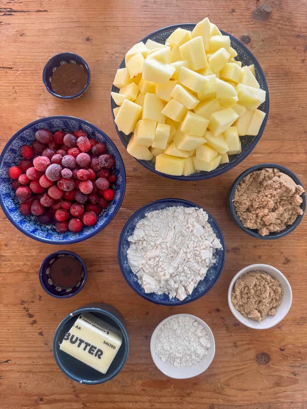 Ingredients needed to make cranberry apple crumble: apples, cranberries, all-purpose flour, brown sugar, salted butter, apple pie spice and vanilla