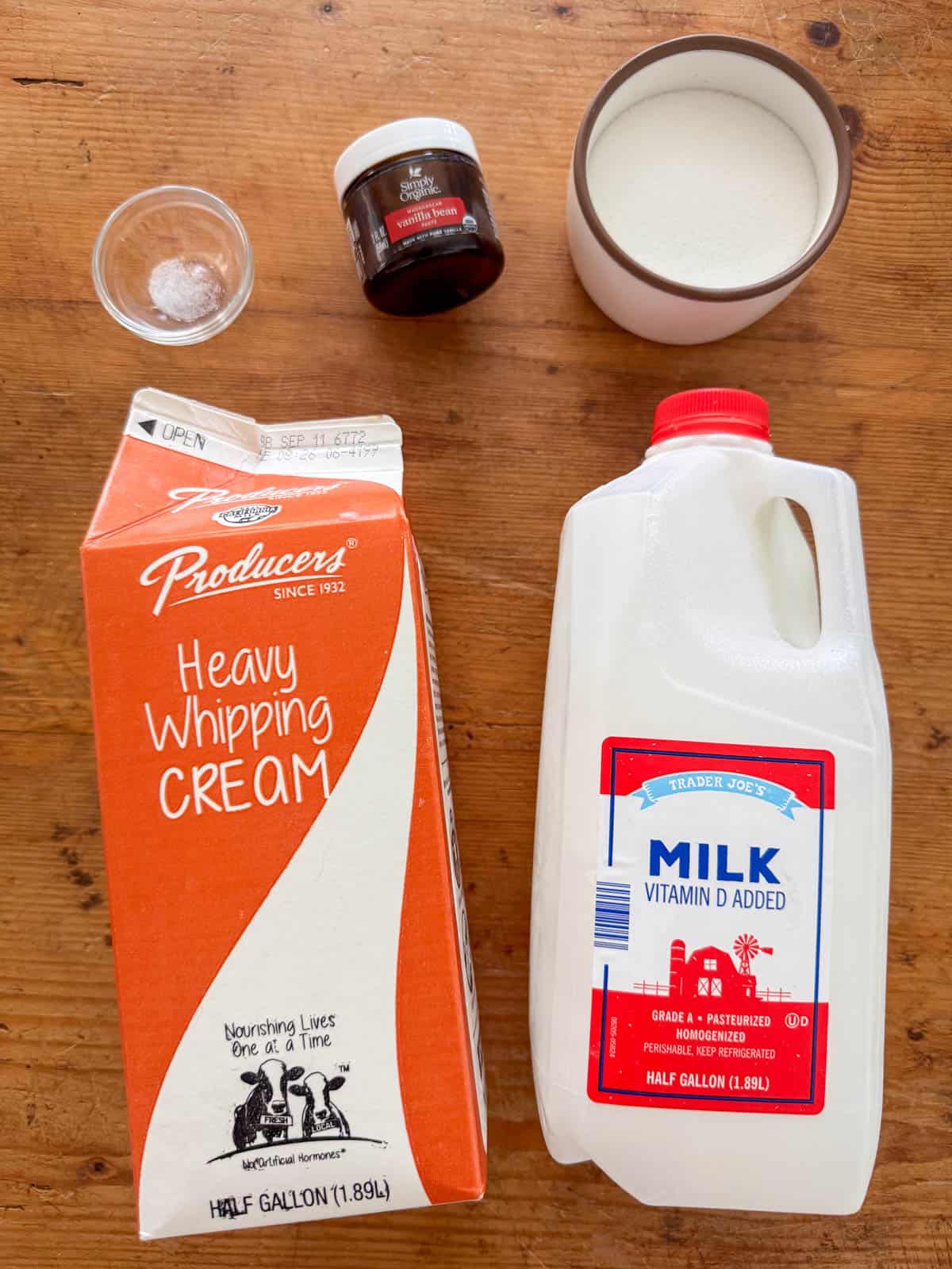 Ingredients needed to make vanilla bean ice cream: heavy whipping cream, whole milk, white sugar, vanilla bean paste and salt.