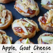 Close up overhead photo of apple, goat cheese and fig jam crostini on a slate platter with a title overlay that says Apple, Goat Cheese & Fig Jam Crostini