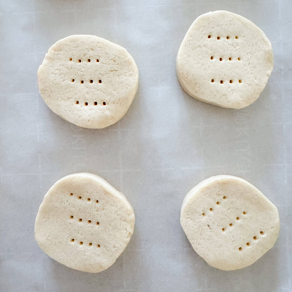 Overhead view of unbaked dairy free shortbread cookies after pricking them with a fork