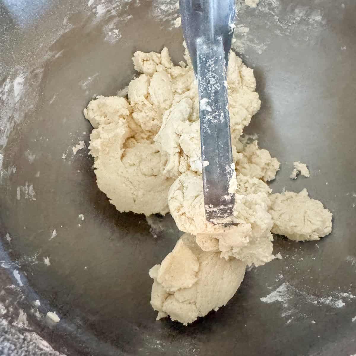 Step 2 of making dairy free shortbread cookies: add flour to cream dairy free butter and sugar. Mix just until flour has been incorporated and dough is crumbly.