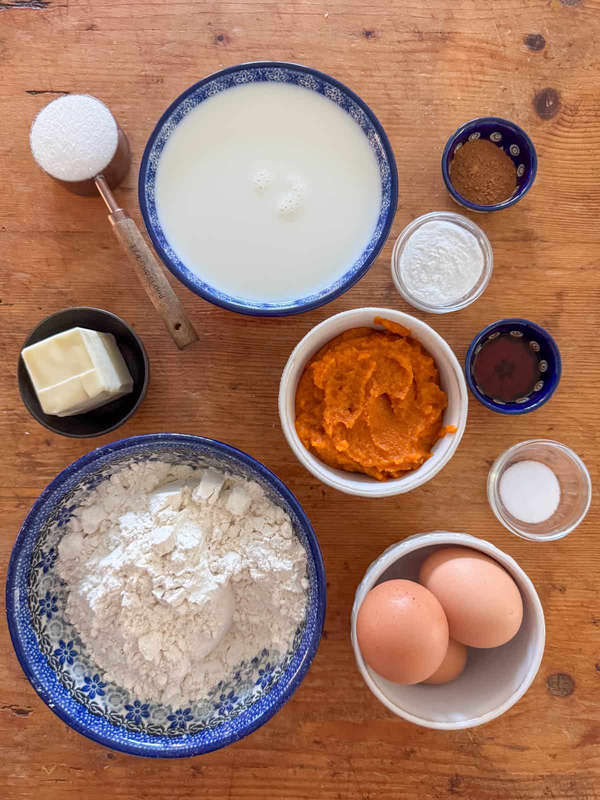 Ingredients needed to make pumpkin spice waffles: all purpose flour, white sugar, pumpkin spice, baking powder, salt, eggs, pumpkin puree, whole milk, butter and vanilla.