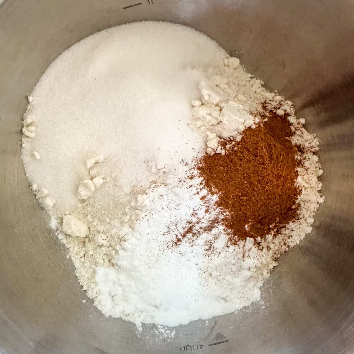 First step in making pumpkin spice waffles: put all-purpose flour, sugar, pumpkin pie spice, baking powder and salt in a large bowl and mix well.